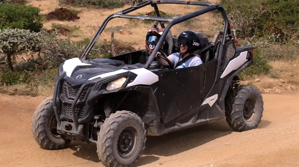 Couple riding a Side by Side UTV on a dirt trail in the Los Cabos desert