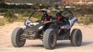 Couple driving a Can-Am Maverick X3 during off road desert tour in Los Cabos